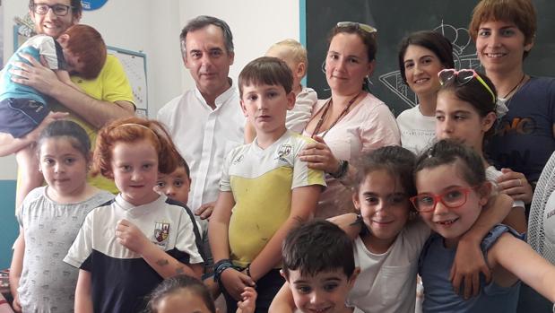Javier y su familia junto al director del programa a los niños que se benefician del programa Ángeles en Dos Hermanas