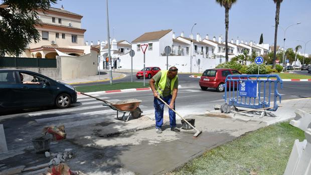 Un operario trabaja sobre el paso de peatones de la Avenida del Aljarafe de Tomares